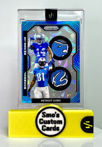 Calvin Johnson / Amon-Ra St. Brown Prizm Blue Dual Lions Patch 1/1